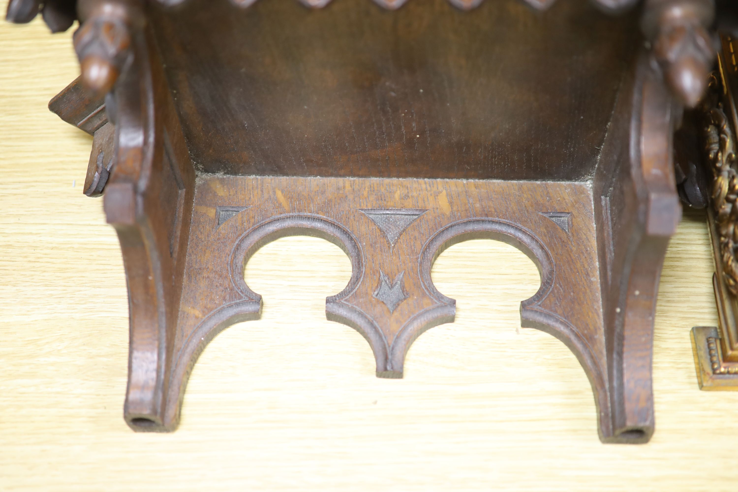 A late 19th century French cast brass cased eight day mantel clock and a carved oak clock bracket, height 50cm